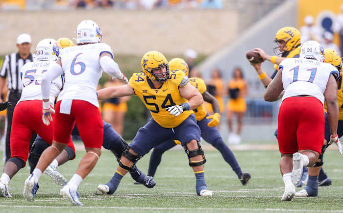 Sep 10, 2022; Morgantown, West Virginia, USA; West Virginia Mountaineers offensive lineman Zach Frazier (54) blocks during the first quarter against the Kansas Jayhawks at Mountaineer Field at Milan Puskar Stadium. Mandatory Credit: Ben Queen-USA TODAY Sports